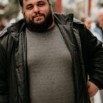 Portrait of a casually dressed man outdoors, capturing urban life and style.