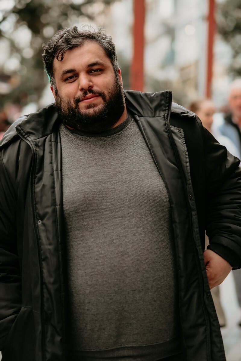 Portrait of a casually dressed man outdoors, capturing urban life and style.